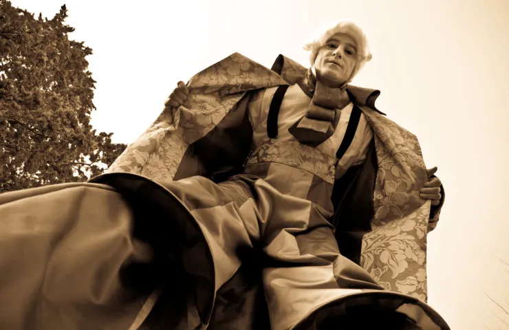 foto contrapicada en color sepia, hombre vestido de época victoriana